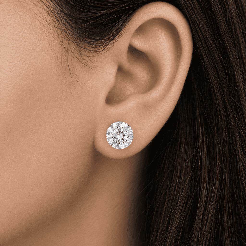 Woman wearing a Gabriel Edward Jewelers classic round diamond stud earring