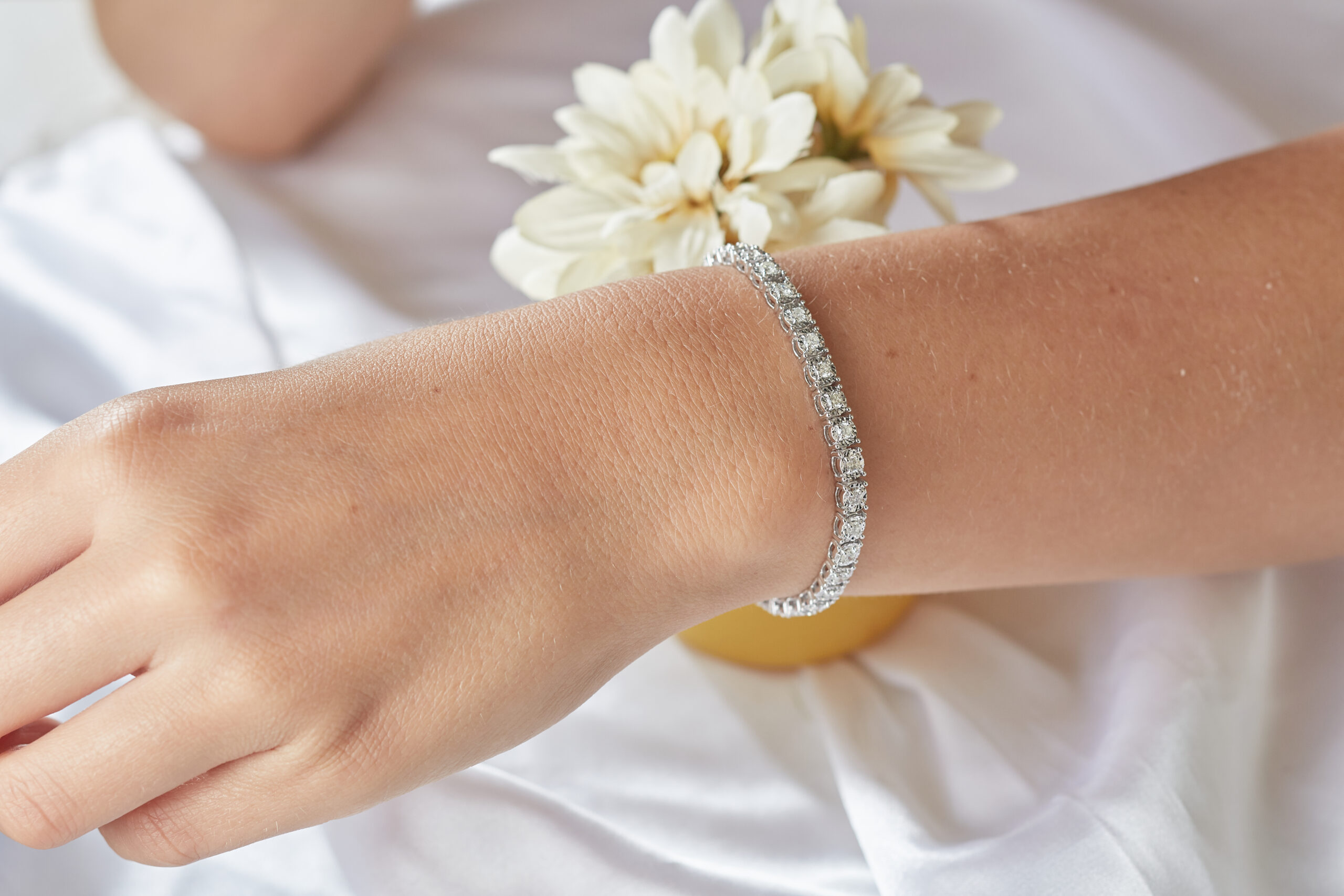 Woman wearing tennis bracelet on wrist