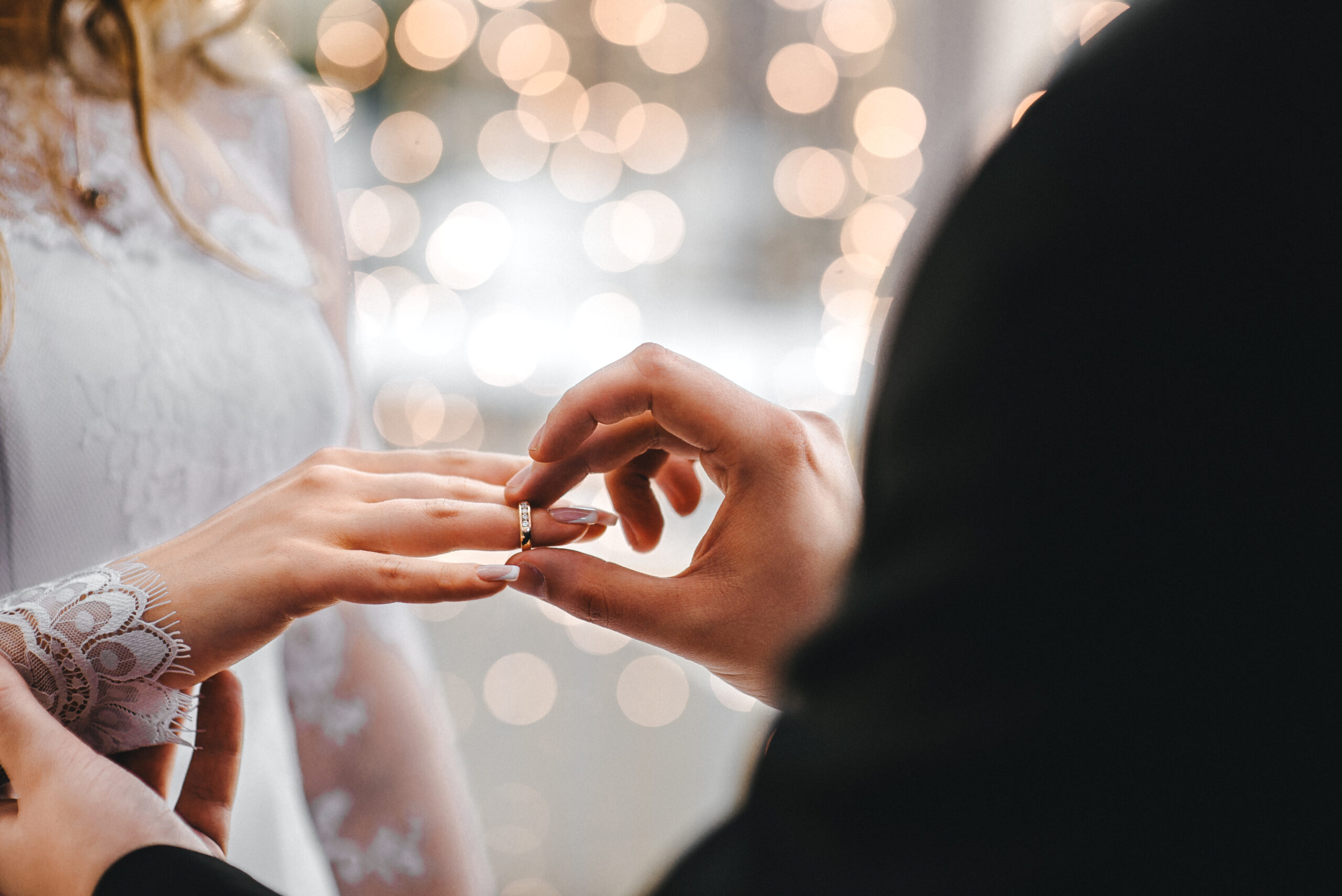 Man putting ring on his wife