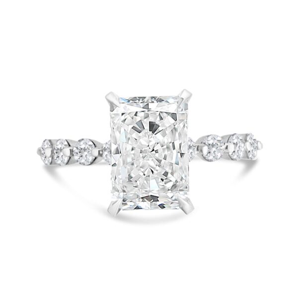 Round diamond accented engagement ring with radiant-cut center diamond