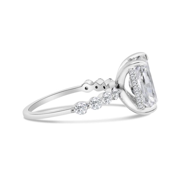 Round diamond accented engagement ring with radiant-cut center diamond
