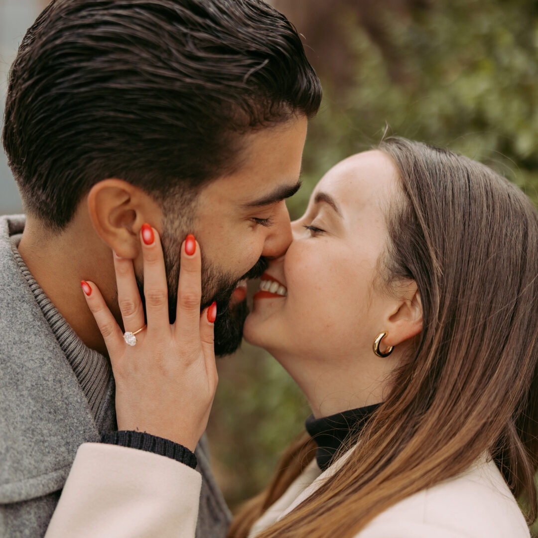 Young couple embracing after beautiful proposal with engagement ring